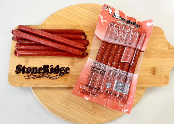 Bloody Mary Meat Sticks  (7 ounces, 7 sticks) on a cutting board.