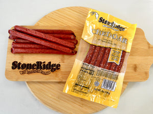 Cheddar Meat Sticks (7 ounces, 7 sticks) on a cutting board.