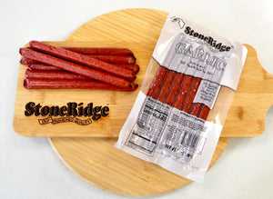 Garlic Meat Sticks (7 ounces, 7 sticks) on a cutting board.