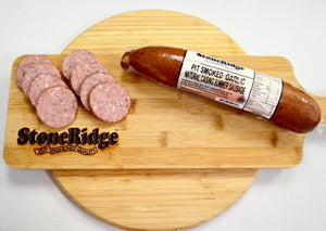 Pit Smoked Garlic Natural Casing Summer Sausage  - 16 Ounce Package on a cutting board.
