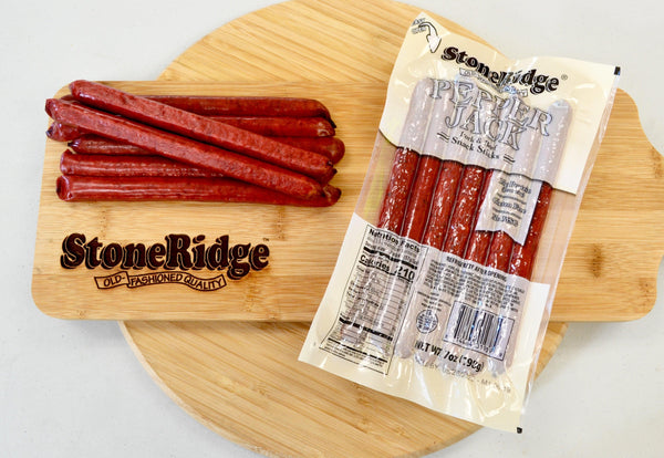 Pepperjack Meat Sticks (7 ounces, 7 sticks) on a cutting board.